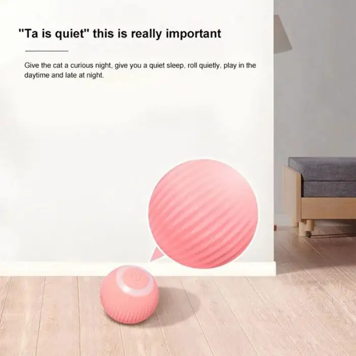 Image of a pink, textured ball toy on a wooden floor in a minimalistic room. The wall text describes the 9484-d8d460.jpg's benefits for a quiet night and playful daytime for a cat. This interactive and luminous toy adds excitement, ensuring endless fun while being USB-charged for convenience.