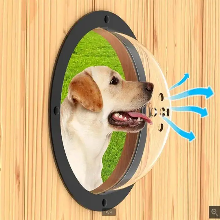 A dog looks through a clear dome-shaped pet window in a wooden fence, with arrows indicating airflow coming through holes in the 10188-fbe455.jpg.