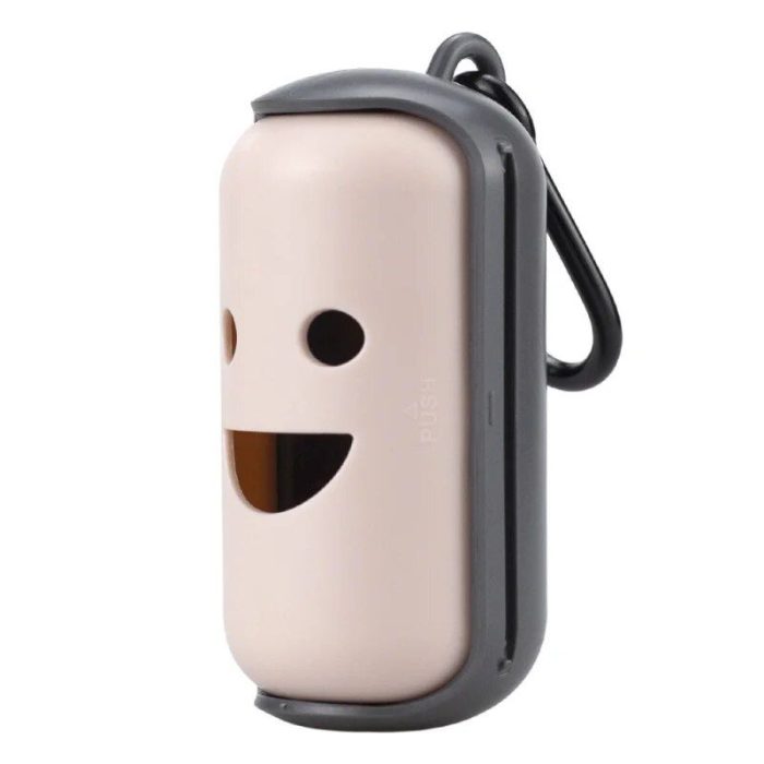 A portable, beige cylindrical container with a face-like design featuring two round eyes and a smiling mouth, attached to a gray frame with a carabiner—ideal as a poop bag dispenser for your pets, 10207-5940ff.jpg.