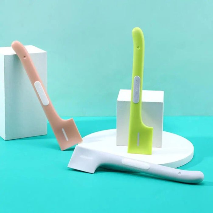 Three colorful flat-edged cleaning scrapers with ergonomic handles, perfect for scraping stubborn residue off spoons, are displayed against a blue background; one pink, one green, and one white. (Product Name: 10307-b303e3.jpg)