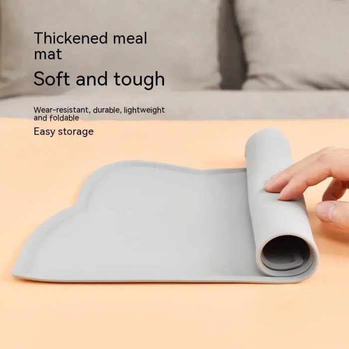 A hand rolling up a soft, gray, thickened cat feeding mat on a beige surface. Text on the image highlights its features such as being soft, tough, wear-resistant, durable, lightweight, and easy to store (Product Name: 10468-5f5293.jpg).