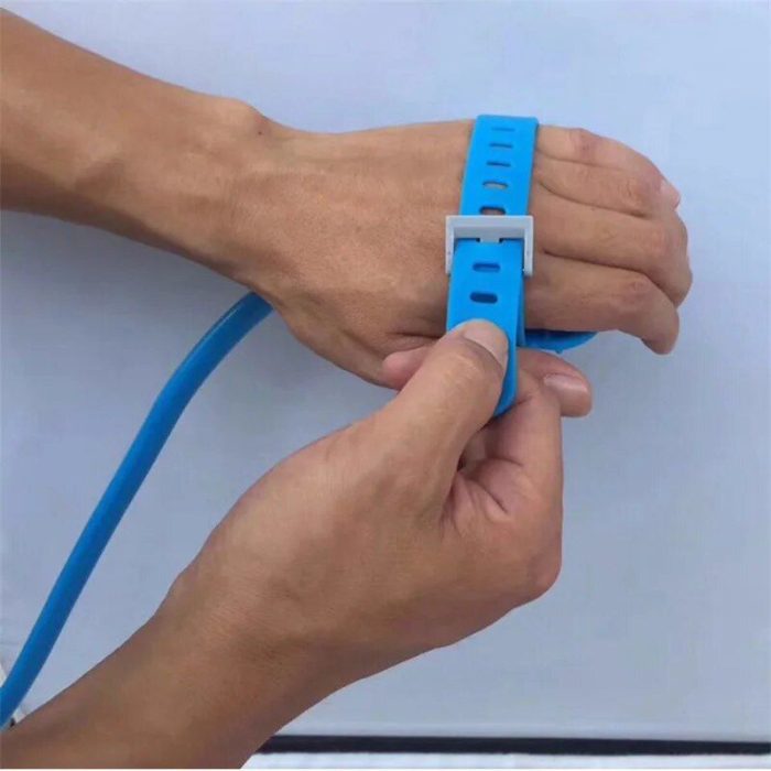 Hands are shown tightening a blue plastic strap around the wrists, reminiscent of preparing for a pet shower, pulling the strap through a clasp, 10652-b27b61.jpg.