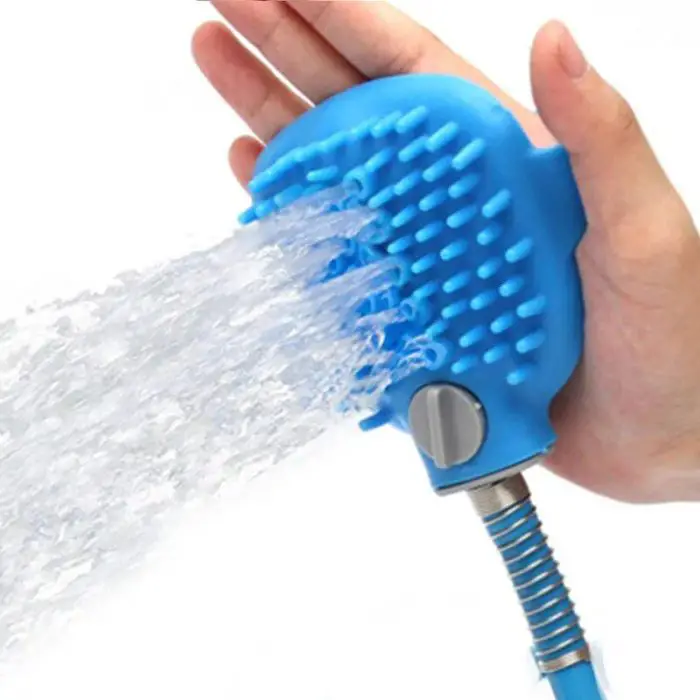 Hand holding a 10652-e9f00d.jpg with water spraying out, featuring rubber bristles and a hose attachment for an efficient pet shower.