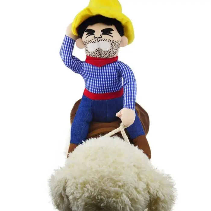 A 10673-944ebd.jpg, clad in a costume featuring a yellow hat and blue checkered shirt, rides on a fluffy sheep.