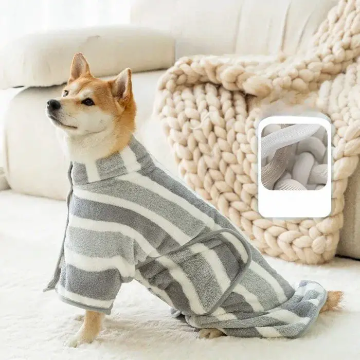 A dog sits on a white carpet wearing 10726-35d682.jpg. A close-up inset shows the robe's soft fabric texture. A beige knitted blanket is in the background.