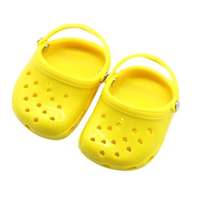 A pair of small, yellow, plastic clog shoes with heel straps and ventilation holes on the upper surface, 10769-655a99.jpg.