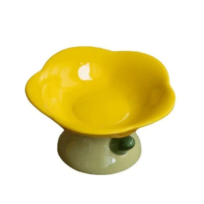 A yellow petal-shaped pet bowl on a beige base with a small green decorative element, 10869-34d8c4.jpg.