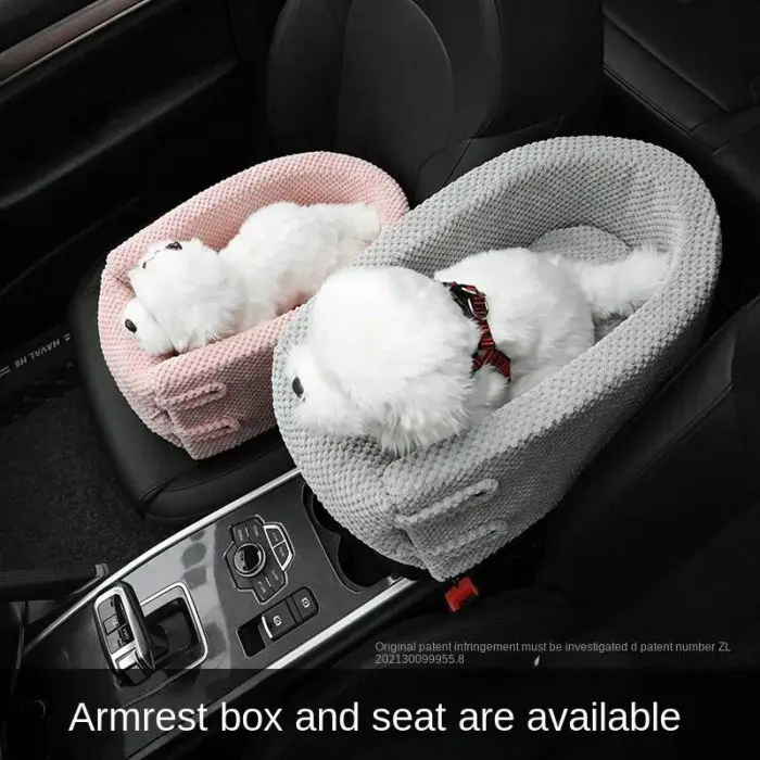 Two car seats feature plush dog toys secured in 10958-7a1e7a.jpg with cushioned armrests, one in pink and one in grey, on the passenger seat and center console. The textured armrest pet seats are cozy and stylish.