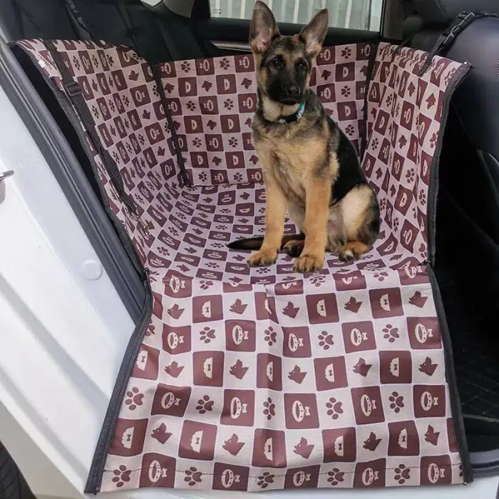 A German Shepherd puppy sits on a 11084-ab63d4.jpg, nestled comfortably in the backseat of a car.