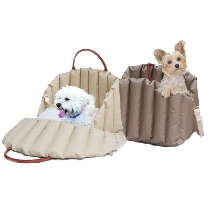 Two small dogs sit inside brown, soft-sided pet carriers. One carrier is open, revealing a white dog inside, while the other carrier is closed with a tan dog peeking out. These versatile carriers can easily double as comfortable pet car seats for travel like the 11097-b8919c.jpg.