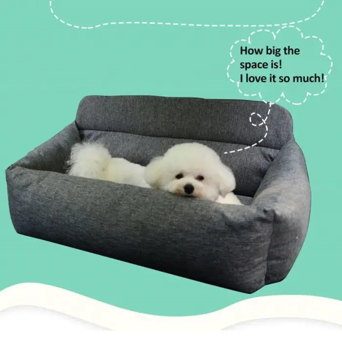 A small white dog lies relaxed on a gray cushioned sofa, imagining himself in 11103-191d3d.jpg with an illustrated speech bubble containing the text, "How big the space is! I love it so much!