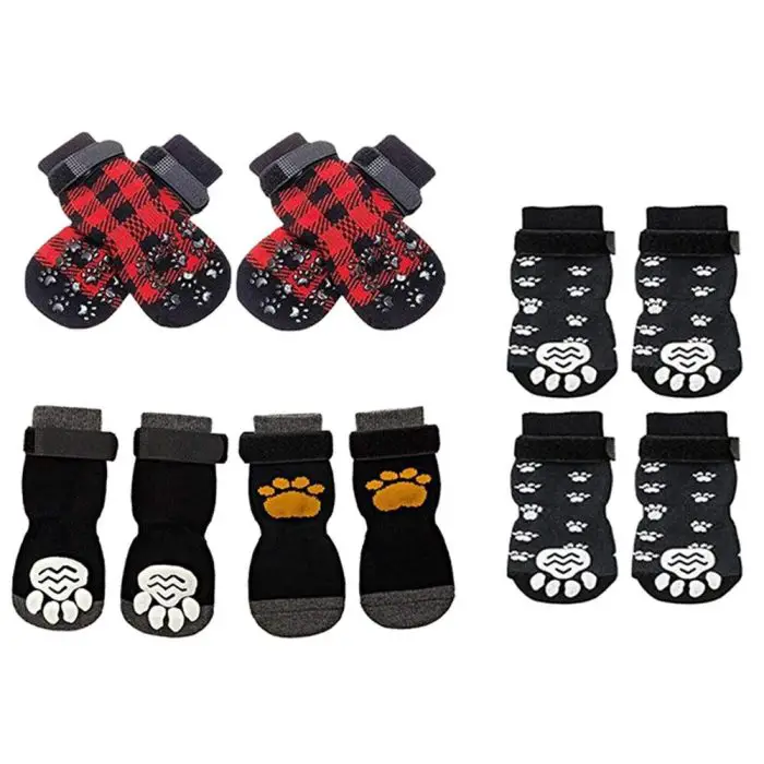 The image titled "11723-4a62fe.jpg" showcases four pairs of pet dog socks with distinct designs: one in red plaid, another in black with paw prints, and two different pairs in black and grey with paw pads on the soles.