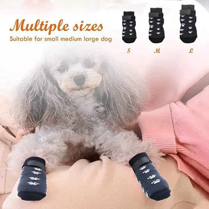 A small dog wearing Pet Dog Socks, featuring black and white paw prints, sits on a cushion in the image. The image also showcases three different sock sizes (small, medium, large), each labeled with the text "Multiple sizes.