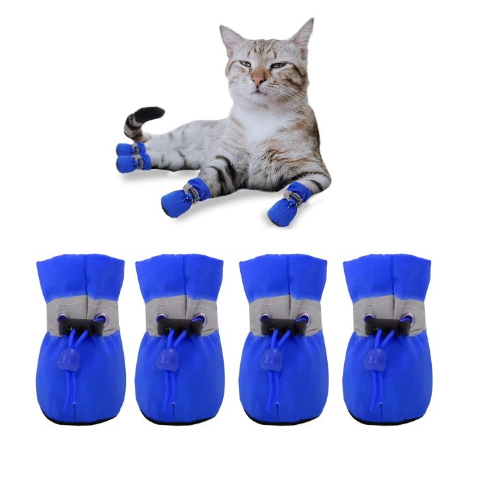 Cat with four blue protective boots from the 11724-e2876b.jpg product line on its paws, lying down, with an additional set of identical blue boots lined up below.