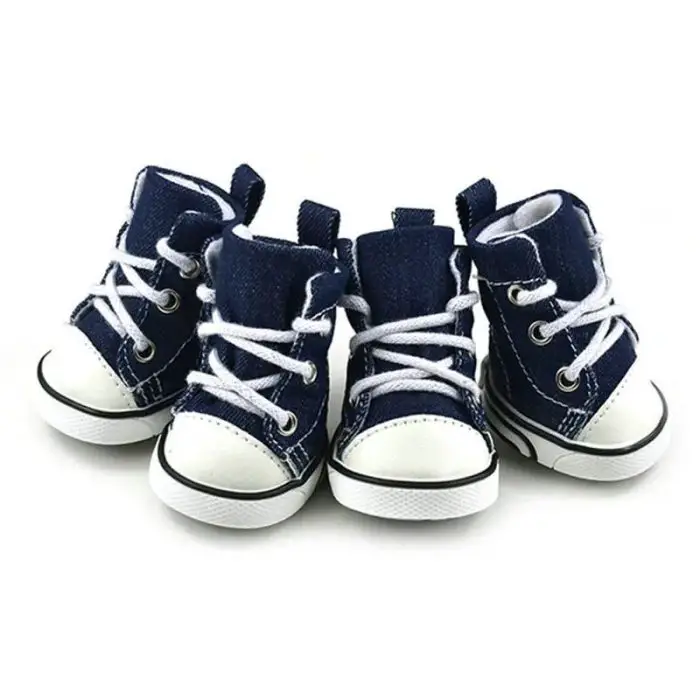 Four pairs of blue denim sneakers, each featuring white laces and soles, are neatly arranged side by side. Perfect for a stylish outing or even a brisk dog sport session, these small-sized shoes ensure both comfort and fashion. (Product: 11821-04b670.jpg)