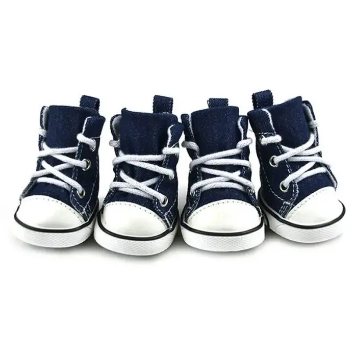 The image titled "11821-53bb8f.jpg" features four miniature navy blue dog sport shoes with white laces and soles, arranged in two pairs on a white background.