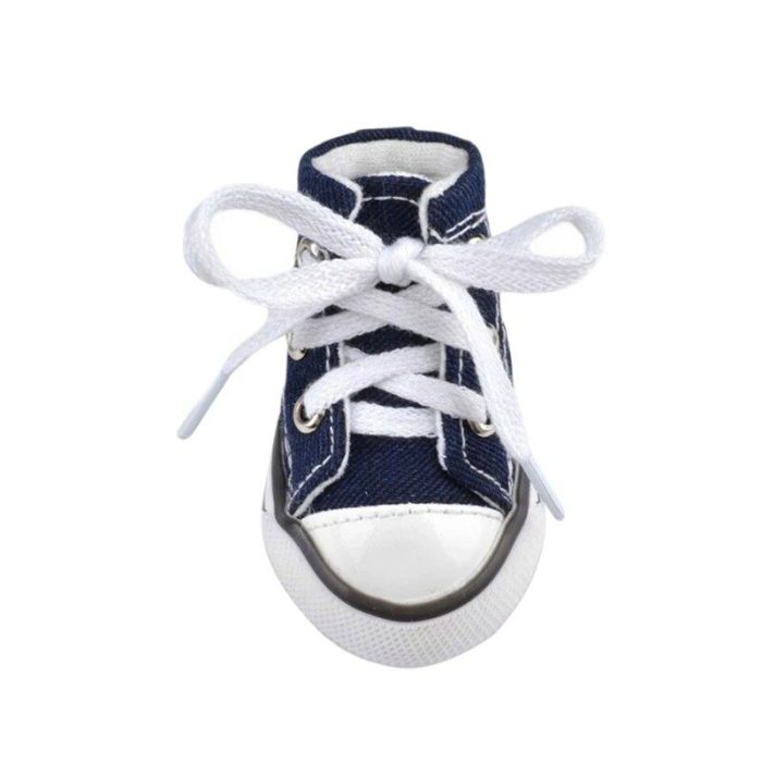 Front view of product 11821-cb0cd6.jpg, a small navy blue and white canvas dog sport sneaker featuring white laces tied in a bow.