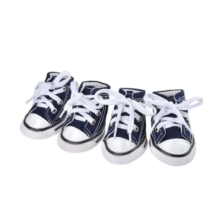 A set of four small, navy blue canvas sneakers with white laces, all neatly arranged side by side on a white background—ideal for any sport-loving or fashion-forward dog. Product code: 11821-de9351.jpg.