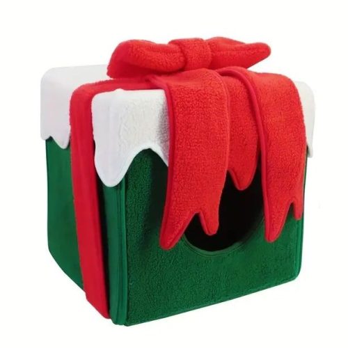 The 12438-b871bb.jpg Christmas Pet Bed is a festive green and white cube designed to resemble a wrapped present, complete with a large red bow on top. It features an opening for pets to enter, making it the perfect holiday hideaway for your furry friends.