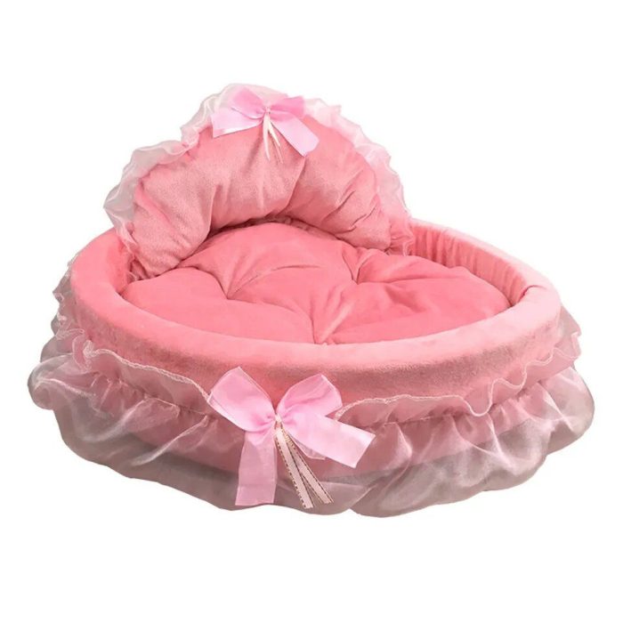 Product 12440-e0712c.jpg is a pink heart-shaped dog bed featuring a lace canopy and adorned with two ribbon bows.