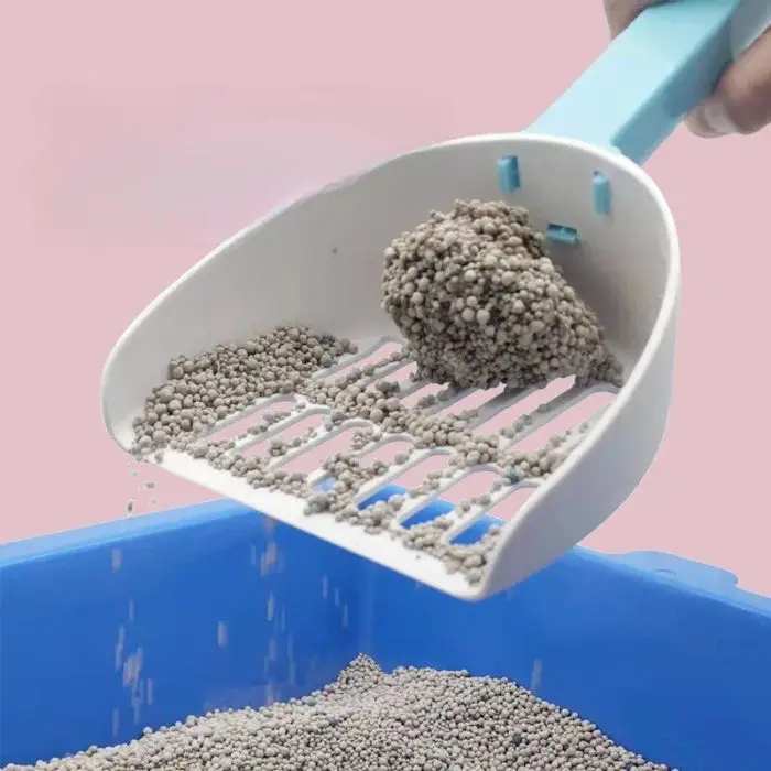 An efficient blue-handled scooper is being used to sift clumping cat litter in a blue litter box against a pink background, as seen in the product image 12585-f1186f.jpg.