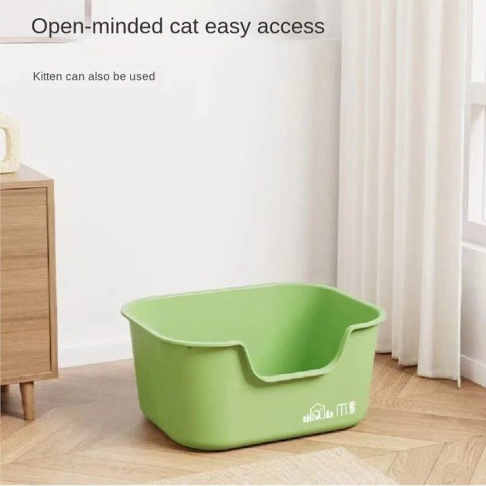 A green, open-topped cat litter box on a wooden floor near a corner window. The text on the image reads: "Open-minded cat easy access. 12587-0e7330.jpg Cat Litter Box can also be used for kittens.