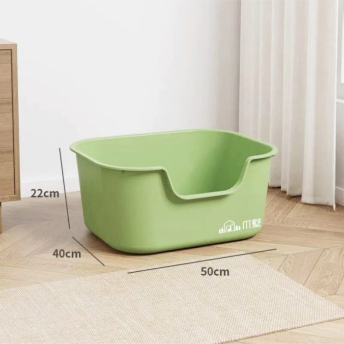 The product, labeled as 12587-858d7d.jpg, is a green plastic storage bin with dimensions of 50cm in length, 40cm in width, and 22cm in height. Resembling a spacious cat litter box, it is placed on a wooden floor beside a beige rug and white curtains.