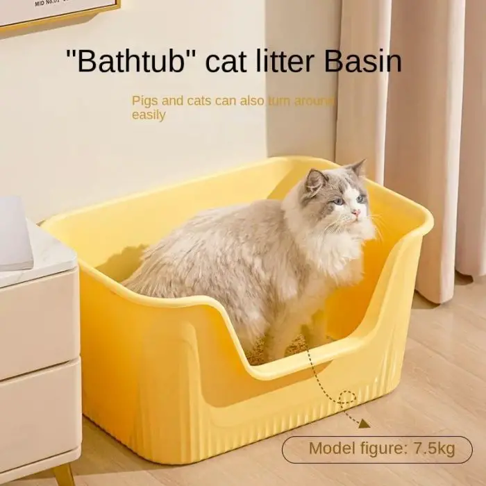 A cat sits in a yellow "Bathtub" cat litter box (12588-595f13.jpg) placed on a wooden floor near beige curtains and a white piece of furniture. Text on the image mentions that pigs and cats can turn around easily.