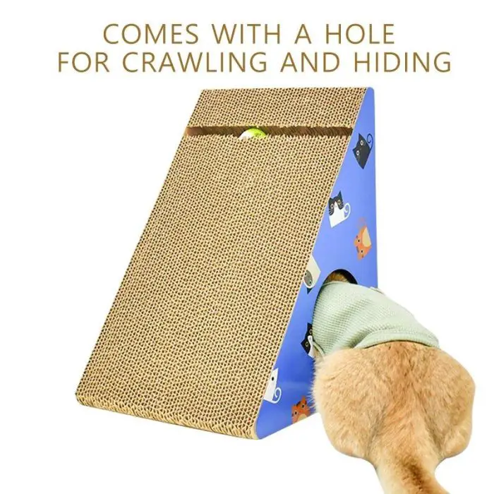 A cat's rear end is visible as it crawls into a 12708-1d96be.jpg cardboard cat scratcher, which features a blue base and a textured, inclined surface. The text above reads "Cat Scratcher comes with a hole for crawling and hiding.