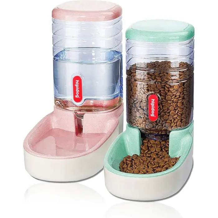 Two automatic cat feeders: both equipped with transparent containers for easy visibility, one with a pink base designed for holding water, and the other with a green base intended for holding dry food. Product Name: 12817-ca997e.jpg.