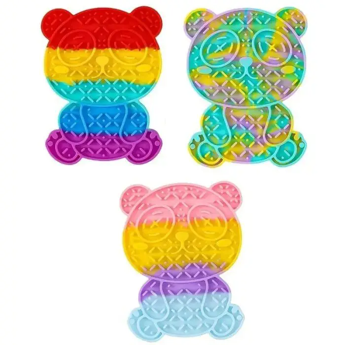 The 12990-980239.jpg product features three bear-shaped pop-it fidget toys in various color schemes: a red, yellow, and blue one; a rainbow-colored one with a clear finish, and a pink, yellow, and blue one. These versatile toys can also serve as bear-shaped silicone slow feeder mats for pets, providing a fun and effective mealtime solution!