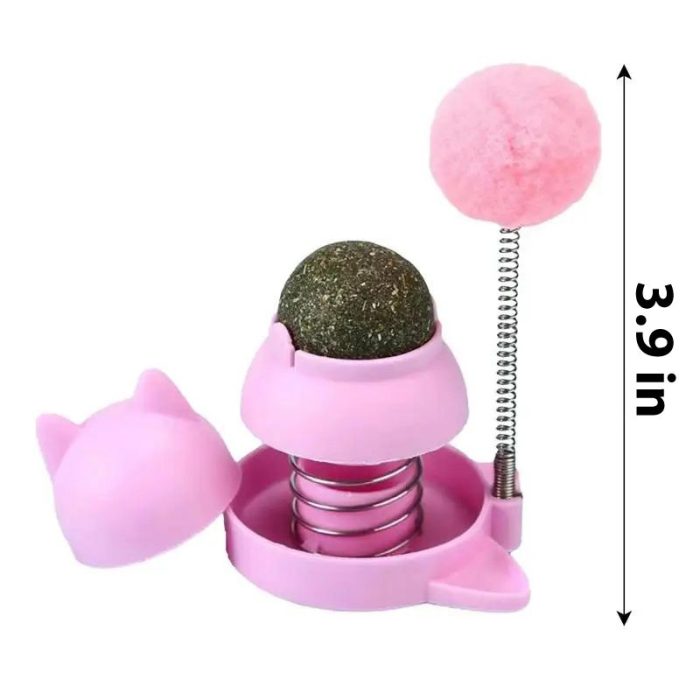 9783-23c8db.jpg with a 3.9-inch height, featuring a spring-loaded base, a pom-pom on top, and a green ball inside a partially open casing with cat ears; it also includes an adhesive catnip ball to entice your feline friend.