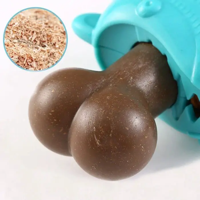 Close-up of a brown object resembling a barbell being inserted into a turquoise plastic device. A circular inset shows a pile of brown shavings, hinting at the bite-resistant durability of 9804-8ac8c7.jpg.