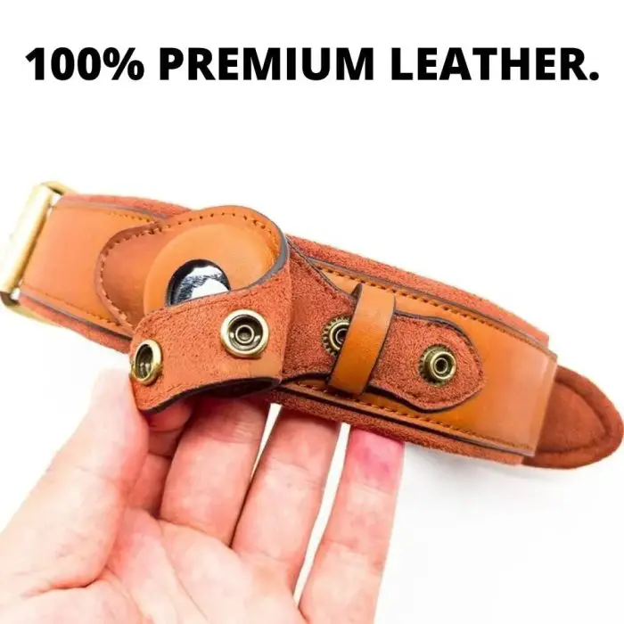 Hand holding a brown leather strap with metal accents under text stating "100% PREMIUM LEATHER." This stylish piece doubles as an adjustable 9912-dc0b2f.jpg pet collar with a reflective design, ensuring both luxury and safety for your beloved pet.